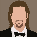 icomania:Man with long brown hair, goattee, and in suit and bowtie.