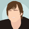 icomania:A man with long brown hair smiling and wearing a black shirt