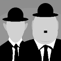 icomania:Two men wearing suits and a bowl hat and one is bigger than the other and has a mustache