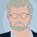 icomania:A man with grey hair and a grey beared with wired glasses and a black coat