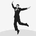 icomania:A man dancing or jumping around in a black tux.