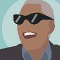 icomania:A black man with white teeth laughing wearing black sunglasses.